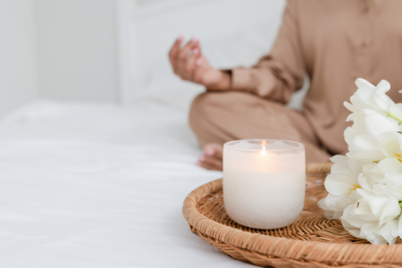 Woman meditating with a candle